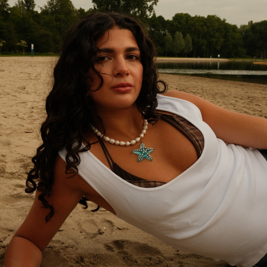 Model wearing the turquoise Ocean Star Pendant styled with a summery outfit and gold jewelry