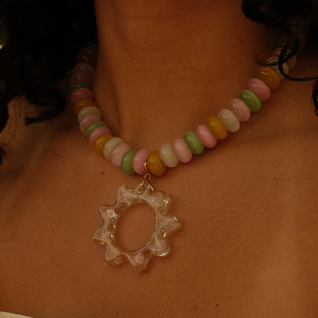 Close-up of the Transparent Sunray Pendant showing the sculptural glass details.