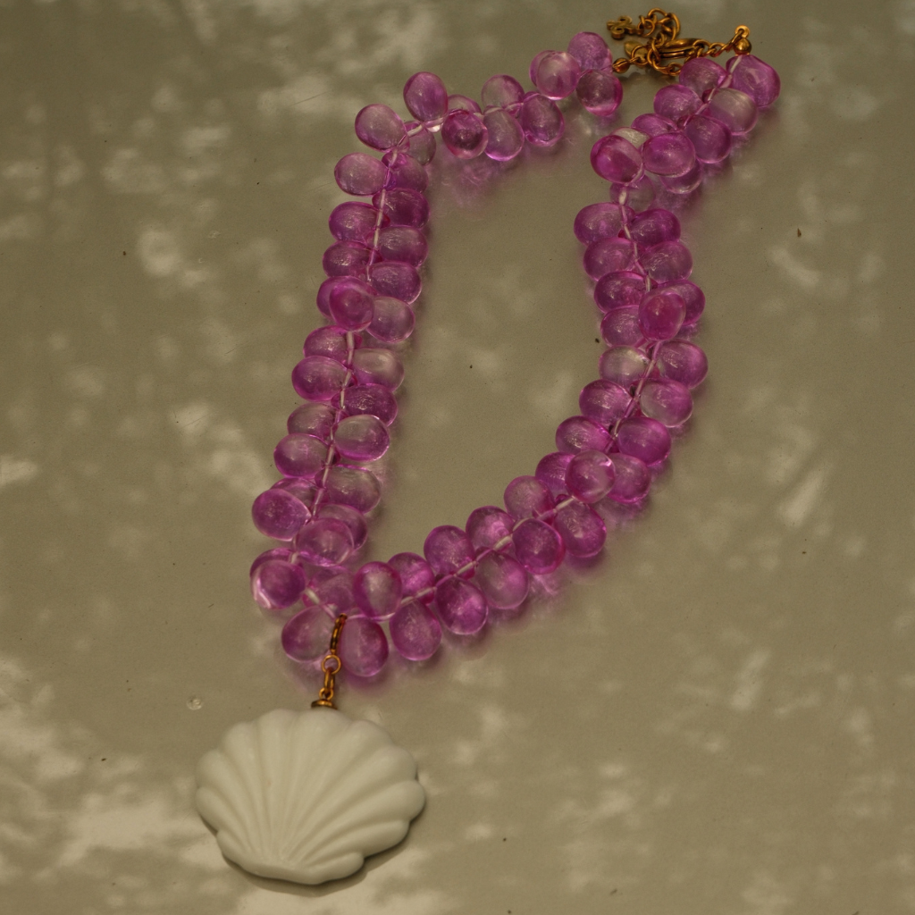 Close-up of the Mermaid 2.0 Pendant with a sculptural white glass shell.